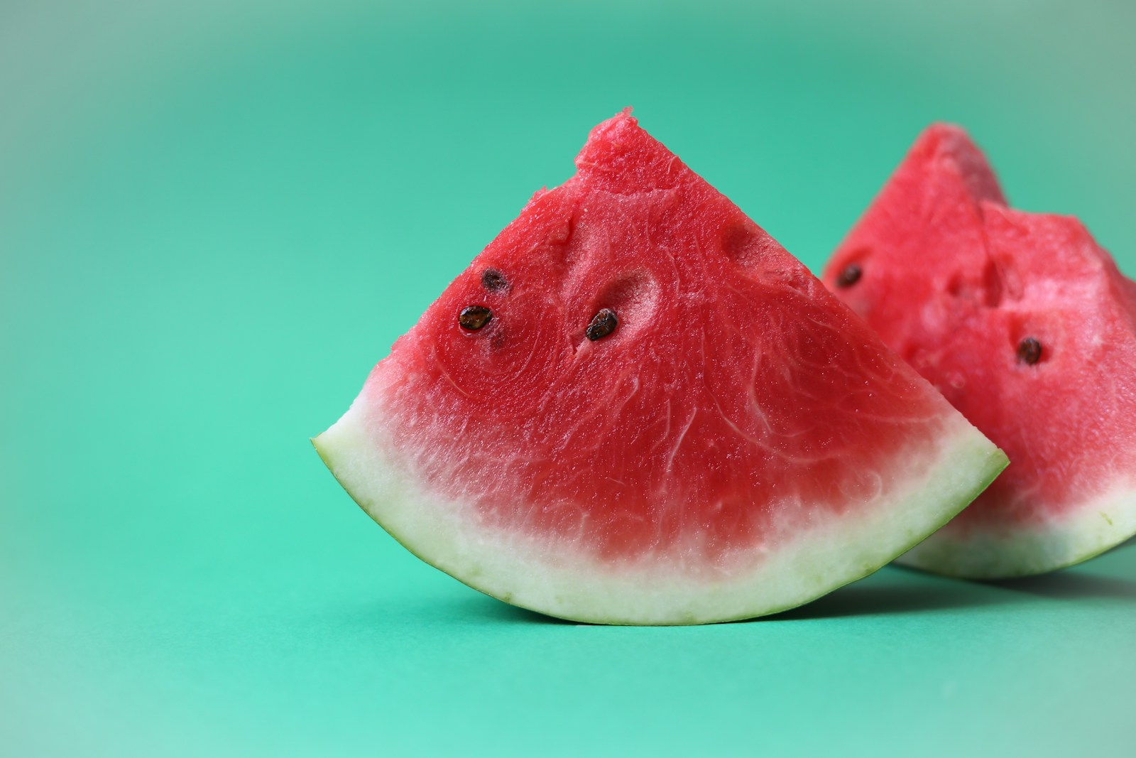 Watermelon wedges showing red flesh, pale rind and dark seeds