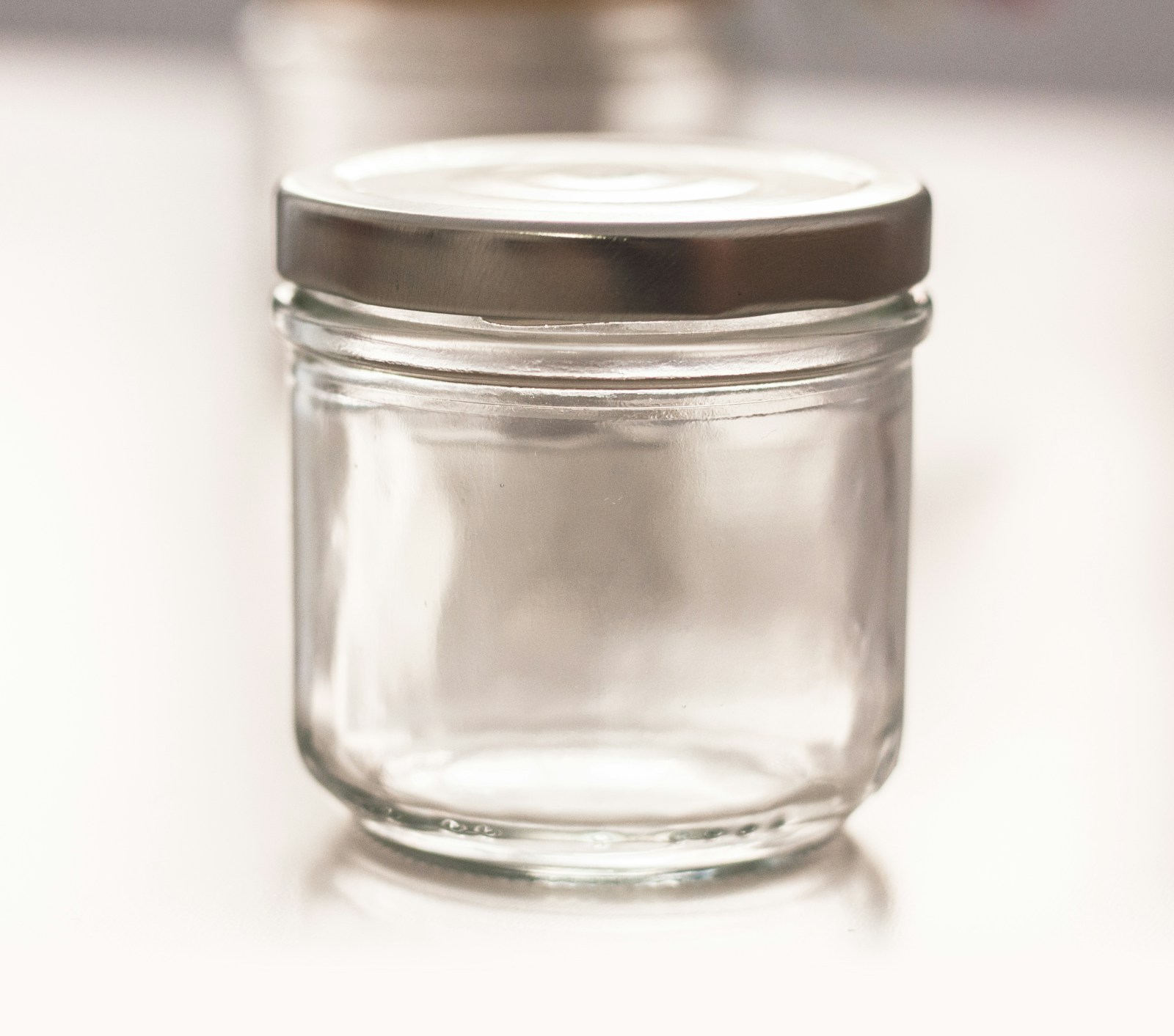 Empty clean glass jar with a metal screw lid